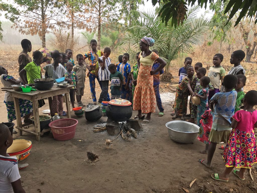 Group of villagers cooking food