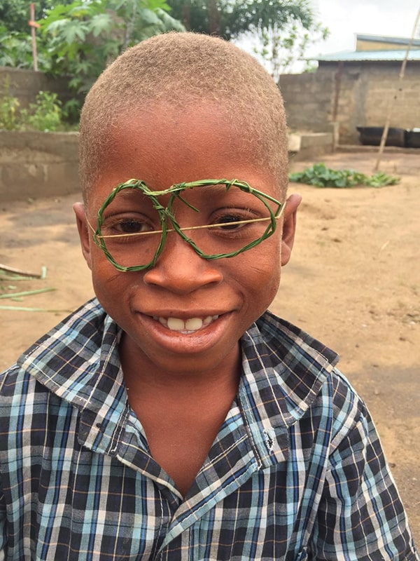 Young boy wearing glasses made out of straw