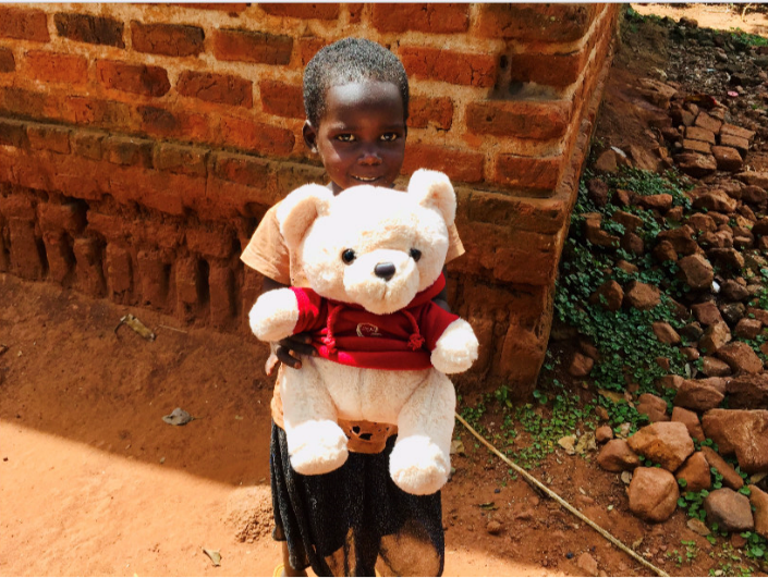 A child in Uganda receives deworming medication.