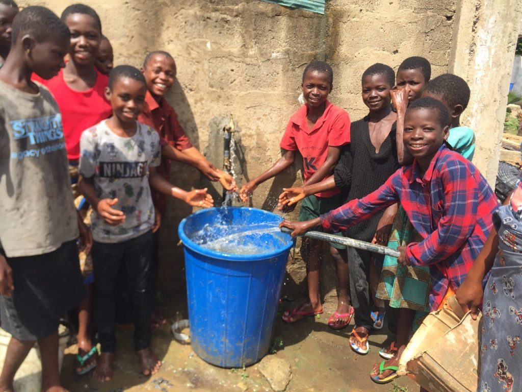 Boys around water well