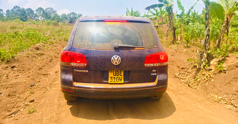 Car being driven over a dirt road